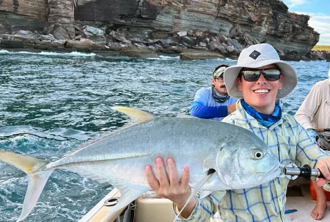 Angler landing a Giant Trevally near the Wessel Islands on a Shimano rod and reel