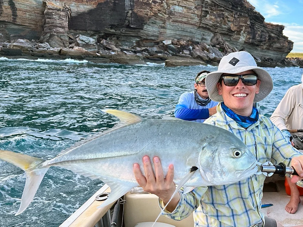 Angler landing a Giant Trevally near the Wessel Islands on a Shimano rod and reel