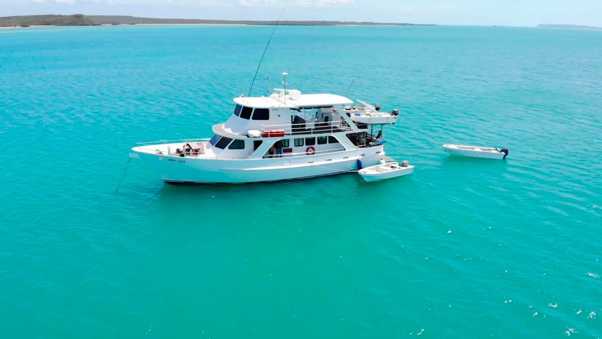 Iron Lady motor yacht anchored in Arnhem Land, with four motored skiffs
