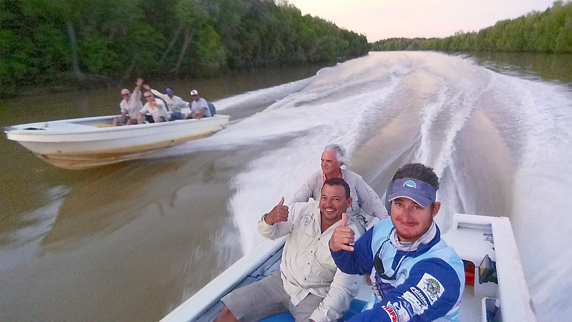 Purpose-built motorised skiffs speeding along an Arnhem Land River, skippered by an experienced guide